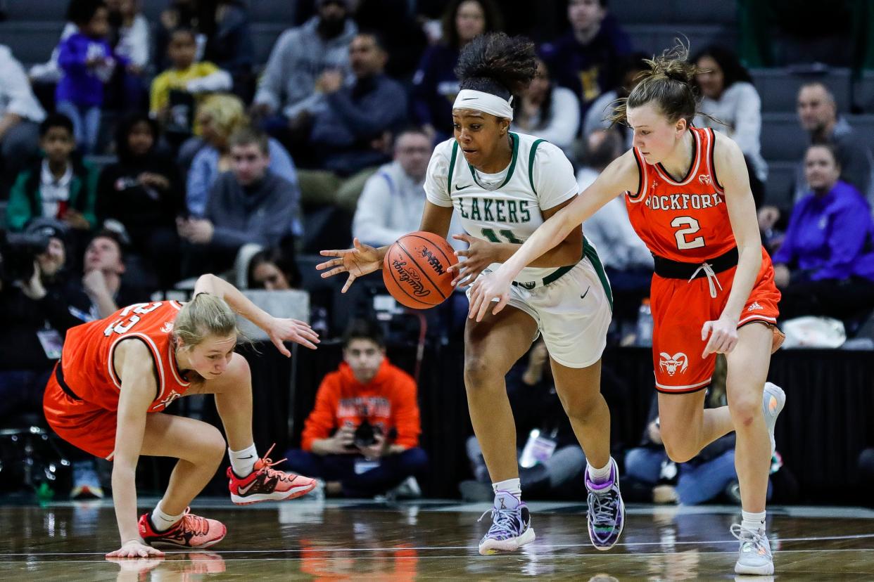 West Bloomfield forward Kendall Hendrix (11) and Rockford guard Anna Wypych (2) battle for the loose ball during the second half of the MHSAA Division 1 girls basketball final at Breslin Center in East Lansing on Saturday, March 18, 2023.