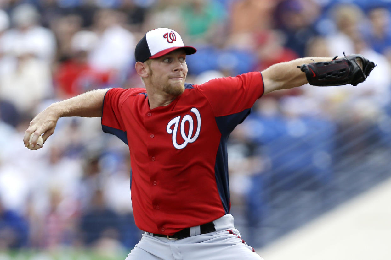 Washington Nationals pitcher Stephen Strasburg throws a pitch during the first inning of an exhibition spring training baseball game in Port St. Lucie, Fla., Saturday, Feb. 23, 2013, in (AP Photo/Julio Cortez)