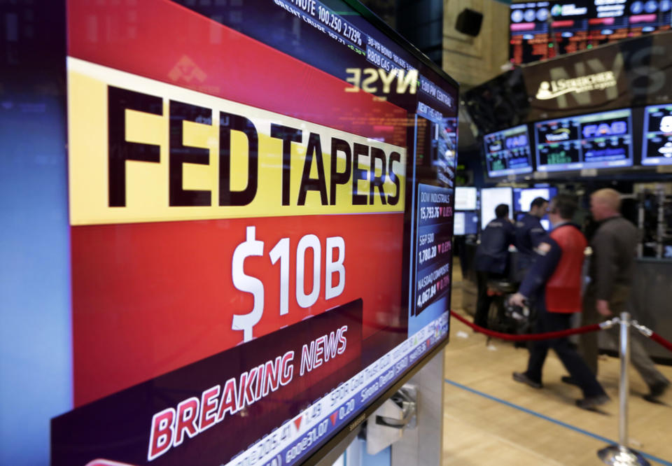 A television screen on the floor of the New York Stock Exchange shows the decision of the Federal Reserve, Wednesday, Jan. 29, 2014. The Federal Reserve says it will cut its monthly bond purchases by an additional $10 billion to $65 billion because of a strengthening U.S. economy. It's doing so even though the prospect of reduced Fed stimulus and higher U.S. interest rates has rattled global markets. (AP Photo/Richard Drew)