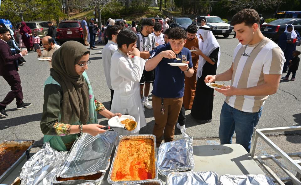 Muslims break thier fast during the Eid al-Fitr celebration at the Worcester Islamic Center on Friday.