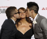 In this April 26, 2012, file photo, Singer Jenni Rivera, center, is kissed by singers Nacho, left, and Chino, right, as they walk the red carpet at the Latin Billboard Awards in Coral Gables, Fla. The wreckage of a small plane believed to be carrying Mexican-American music superstar Jenni Rivera was found in northern Mexico on Sunday, Dec. 9, 2012, and there are no apparent survivors, authorities said. (AP Photo/Wilfredo Lee, file)