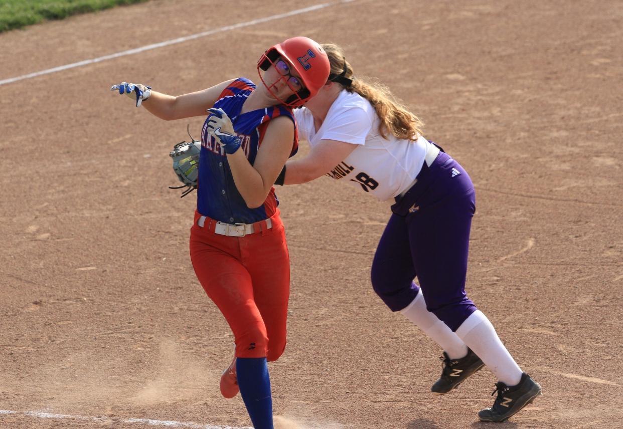 Lakewood's Briana Hoisington attempts to elude the tag of Bloom-Carroll first baseman Rachel Grove on Monday.