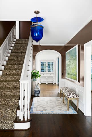 <p>Brian Woodcock; Styling: Page Mullins</p> Chocolate brown warms up the entry of this Atlanta project by Allison Allen.
