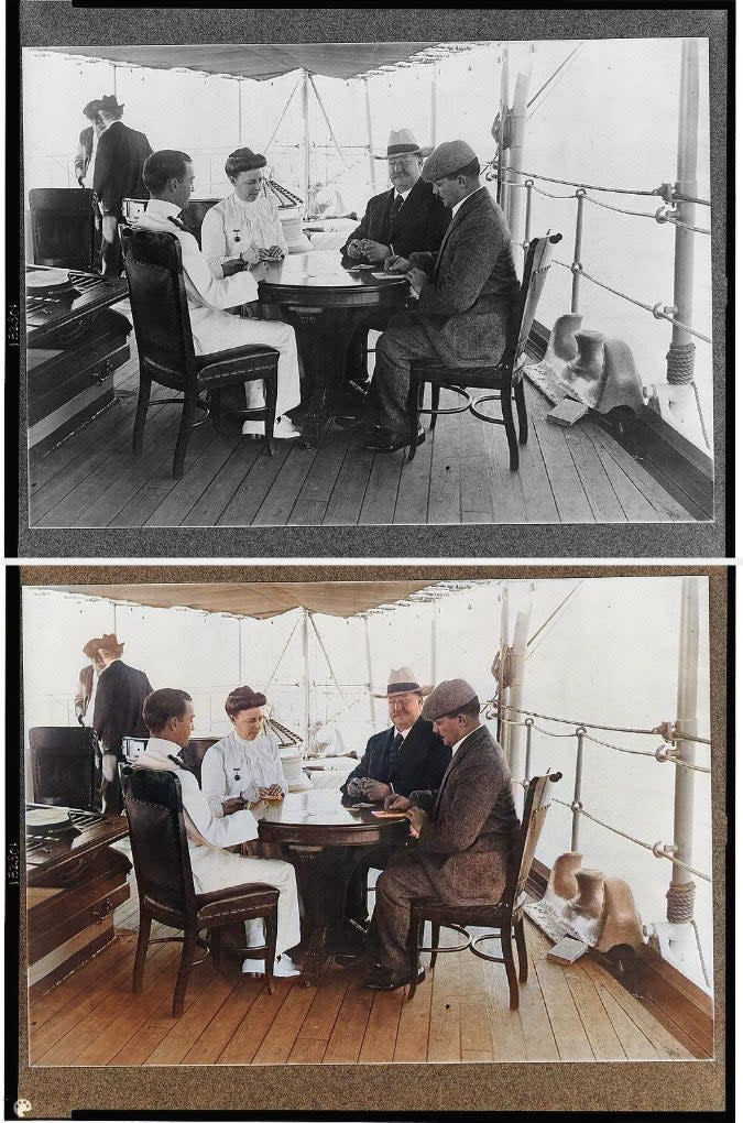 Four people, including two in naval uniforms, are seated around a table on a ship's deck, engaged in conversation