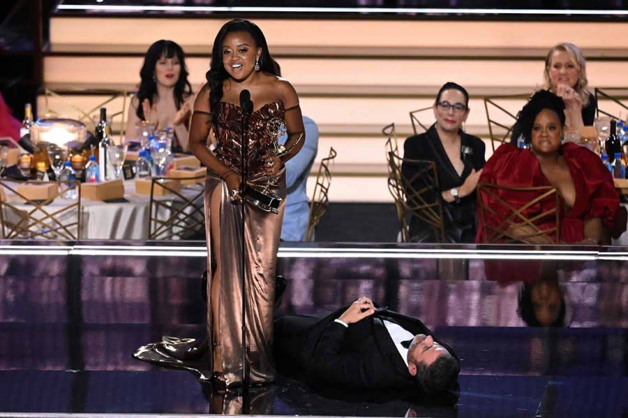 Quinta Brunson delivers her speech at the 74th Emmy Awards with Jimmy Kimmel lying on the ground beside her. (Patrick T. Fallon/AFP via Getty Images)