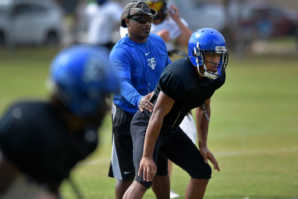 Willie Green directs Trinity Christian linebacker Cameron Anderson in drills during an August 22 football practice. Green, a Trinity assistant for nearly 20 years through seven FHSAA championships, died Sunday at age 56.