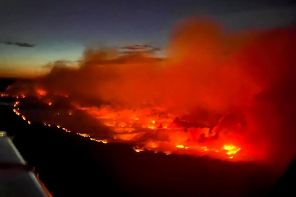 <p>FILE PHOTO: The Parker Lake wildfire glows in an aerial photograph taken by a B.C. Emergency Health Services crew member through the window of an airplane evacuating patients from nearby Fort Nelson, British Columbia, Canada.</p> 