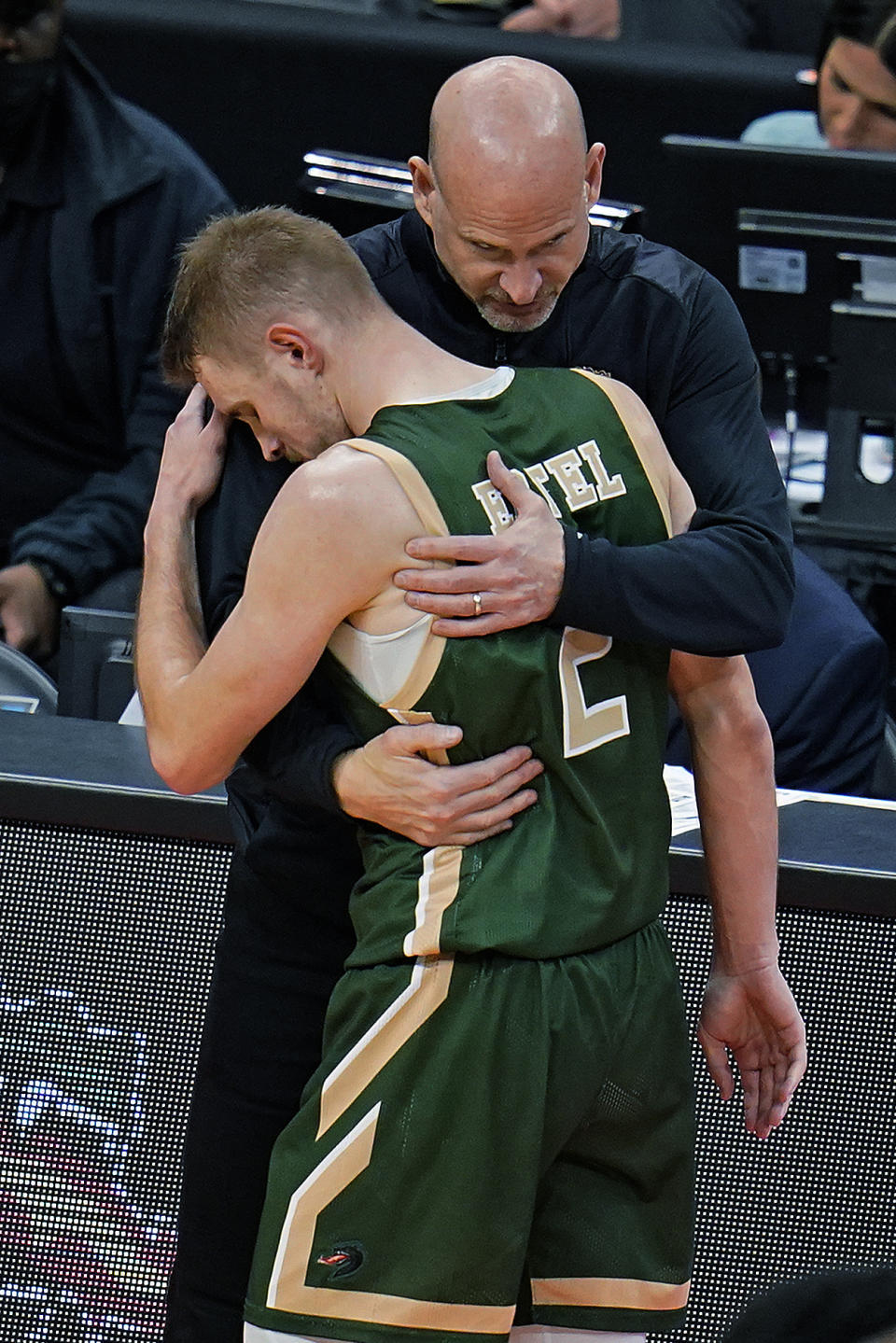 UAB coach Andy Kennedy hugs Michael Ertel (2), who was headed to the bench in the final minute of the team's college basketball game against Houston in the first round of the NCAA men's tournament in Pittsburgh, Friday, March 18, 2022. Houston won 82-68. (AP Photo/Gene J. Puskar)