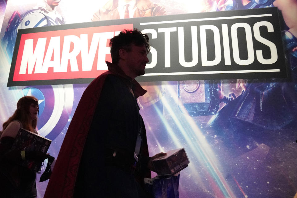 A cosplayer dressed as Doctor Strange passes by a Marvel Studios exhibit at the D23 Expo Saturday, Sept. 10, 2022, in Anaheim, Calif. (AP Photo/Mark J. Terrill)