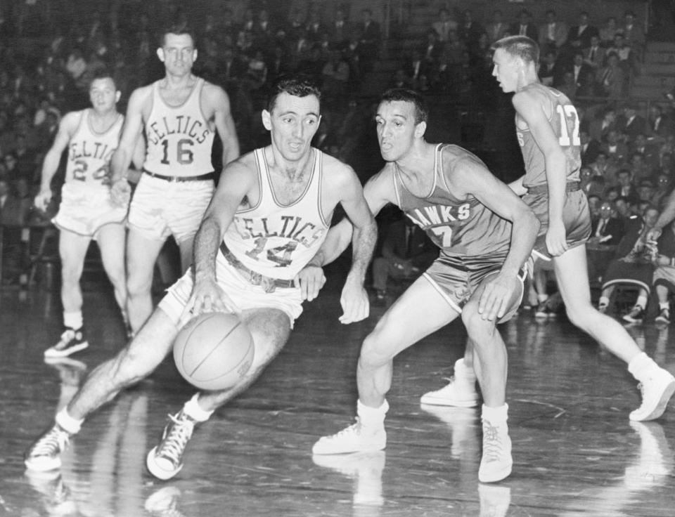 Celtics PG Bob Cousy drives past Hawks PG Bob Harrison during a game in 1954. (Bettmann Archives/Getty Images)