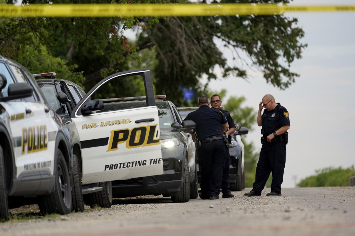 Police protect the scene where officials say dozens of people have been found dead and multiple others were taken to hospitals with heat-related illnesses after a semitrailer containing suspected migrants was found on Tuesday, June 28, 2022, in San Antonio.