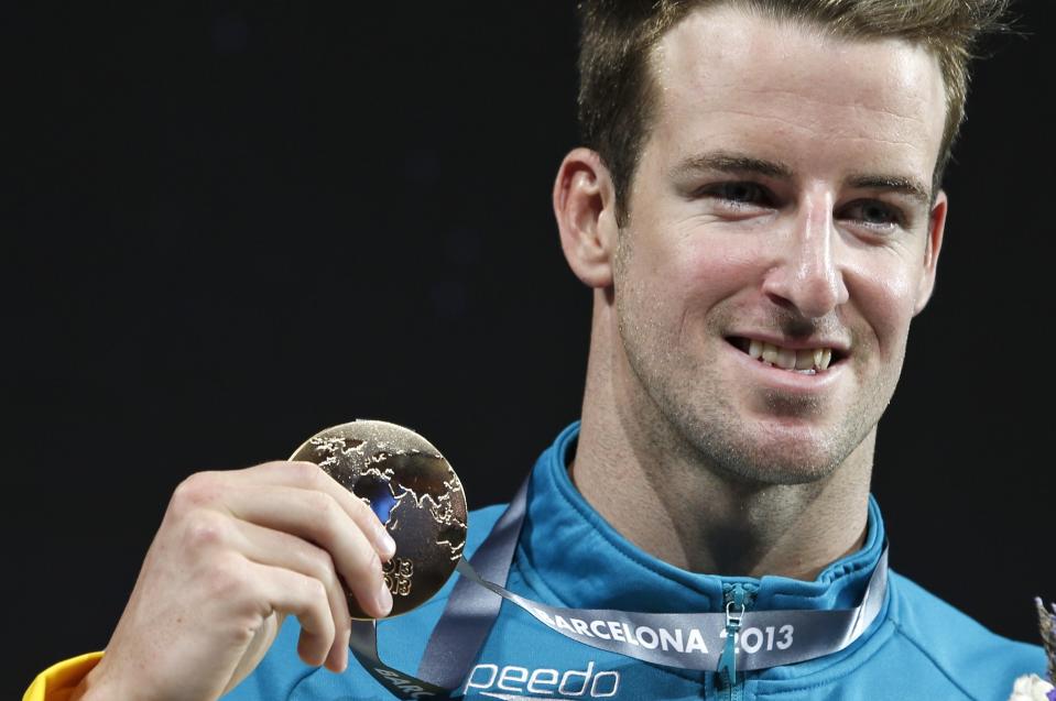 FILE - Australia's James Magnussen smiles as he hold the gold medal he won in the Men's 100m freestyle final at the FINA Swimming World Championships in Barcelona, Spain, on Aug. 1, 2013. Retired swimming world champion James Magnussen faces a series of potential legal and ethical issues after declaring that he will use banned doping substances in an unofficial attempt to break the 50-meter freestyle world record. “I want to approach this the right way,” Magnussen said Friday Feb. 9, 2024 in a post on his Instagram page. (AP Photo/Michael Sohn, File)