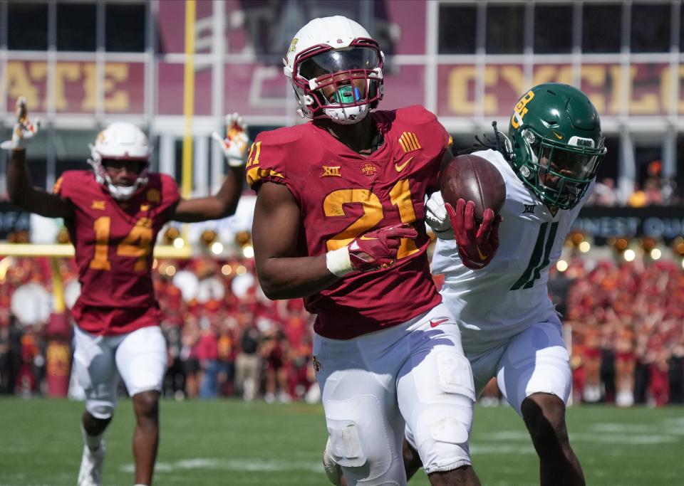 Baylor cornerback Lorando Johnson (11) knocks the ball out of Iowa State running back Jirehl Brock's arm in the fourth quarter at Jack Trice Stadium. Brock recovered the ball in the end zone for an Iowa State touchdown on what was ISU's top run of the game.