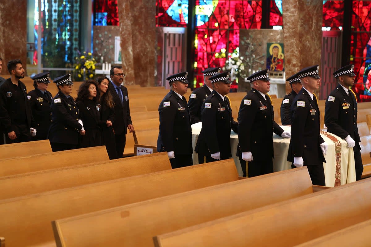 The family of Luis M Huesca follow his casket inside St Rita of Cascia Shrine Chapel on Monday (Antonio Perez/Chicago Tribune via AP)