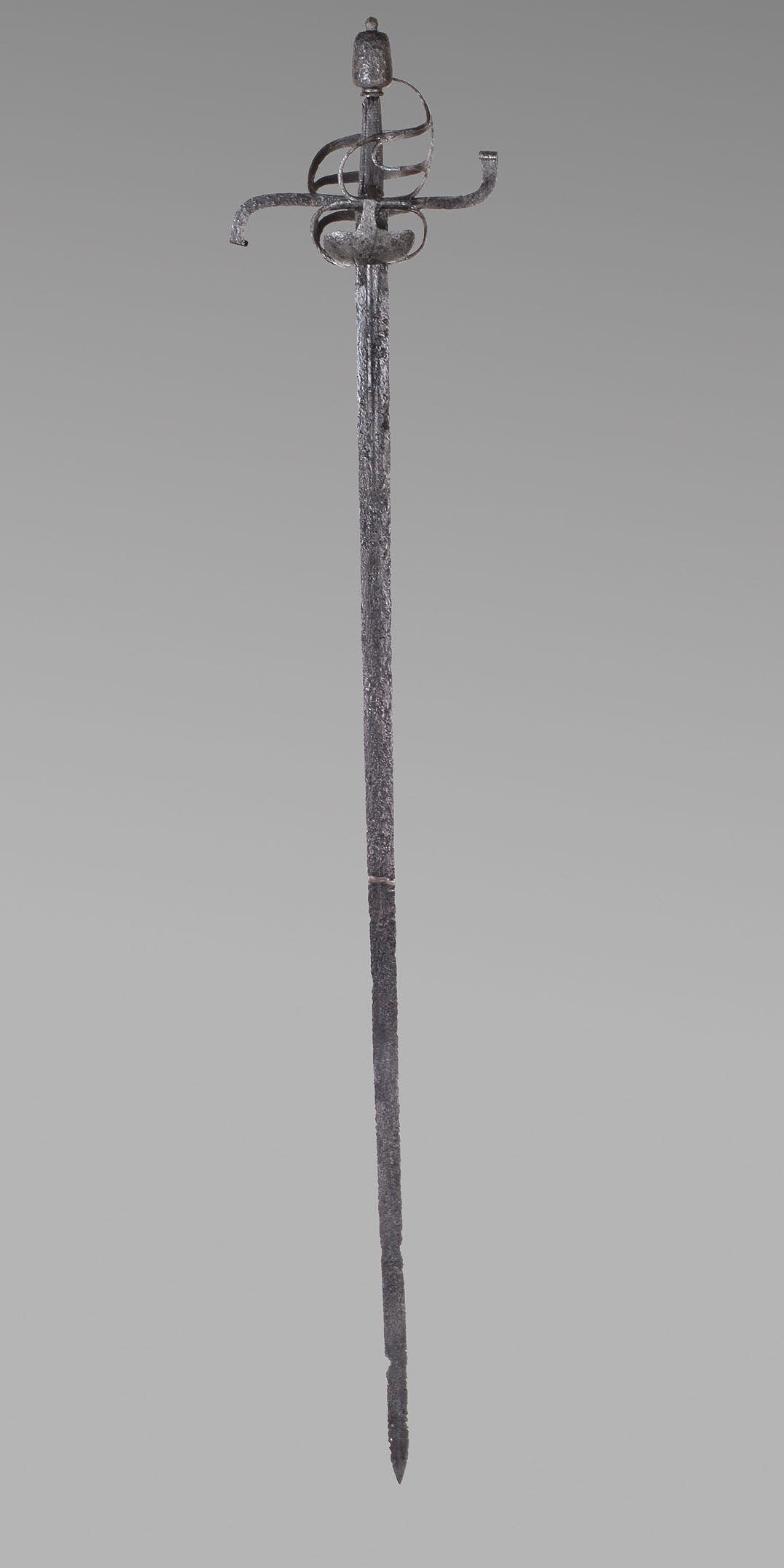 long thin metal sword with thin flowing guard spiraling around the handle