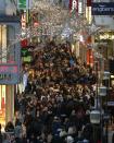 People walk through a shopping street in Essen November 30, 2013. The busy Christmas shopping season traditionally begins on the first Advent weekend in Germany. REUTERS/Ina Fassbender