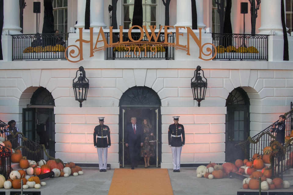 President Donald Trump and first lady Melania Trump arrive to give candy to children during a Halloween trick-or-treat event on the South Lawn of the White House which is decorated for Halloween, Monday, Oct. 28, 2019, in Washington. (AP Photo/Alex Brandon)