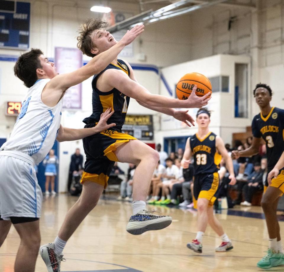 Turlock’s Dutch Lawrence drives to the basket past Downey’s Carson Lamb in the Central California Athletic League game at Downey High School in Modesto, Calif., Friday, Jan. 19, 2024.