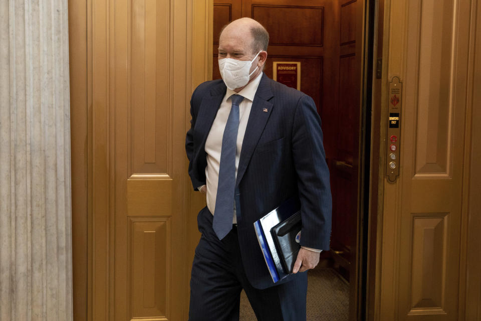 Sen. Chris Coons, D-Del., walks towards the floor of the senate at the Capitol in Washington, Wednesday, Jan. 19, 2022. (AP Photo/Amanda Andrade-Rhoades)