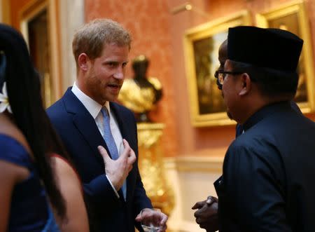 Britain's Prince Harry meets group of Queen's Young Leaders at a Buckingham Palace reception following the final Queen's Young Leaders Awards Ceremony, in London, June 26, 2018. Yui Mok/Pool via Reuters