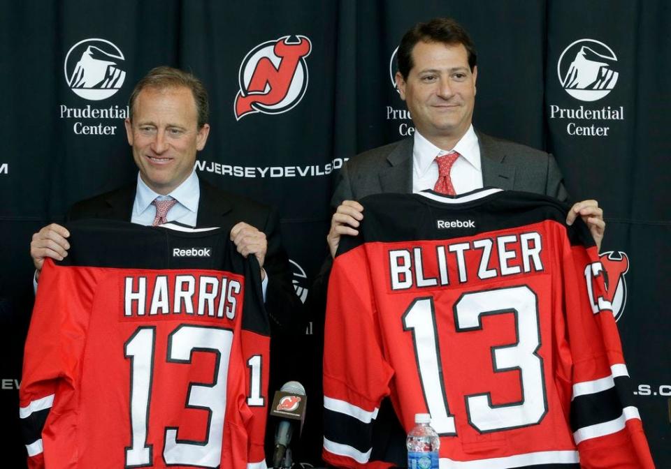 Joshua Harris, left, and David Blitzer — new minority owner of the Guardians — hold New Jersey Devils jerseys with their names during an NHL hockey news conference announcing them as new owners of the team, Thursday, Aug. 15, 2013, in Newark, N.J.