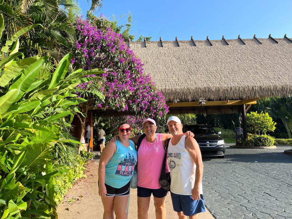 megan and her family posing for a photo in front of discovery cove marine life park in orlando