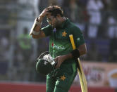 Pakistan's Imam-ul-Haq on his way to pavilion after being dismissed by Sri Lanka, in Karachi, Pakistan, Monday, Sept. 30, 2019. Pakistan play a second one-day international after winning the toss and elected to bat against Sri Lanka. (AP Photo/Fareed Khan)