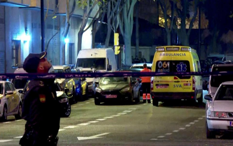 A police officer stands near an ambulance at a cordon outside an arms company's building after it received a letter bomb in Zaragoza, Spain - FORTA