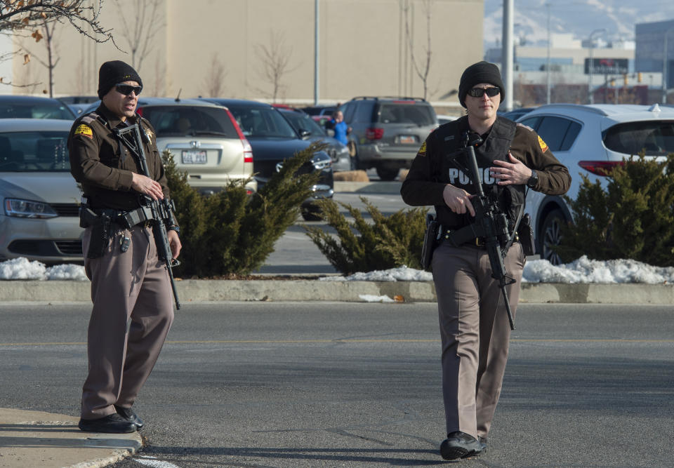 Police patrol the parking lot at Fashion Place Mall in Murray, Utah, after a shooting at Sunday, Jan. 13, 2019. (Rick Egan/The Salt Lake Tribune via AP)