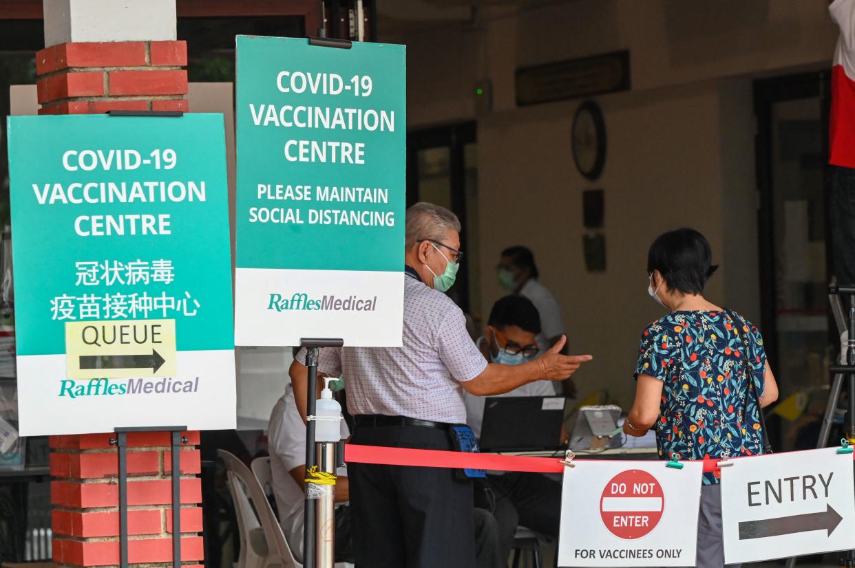 People at a COVID-19 vaccination centre in a community centre in Singapore.