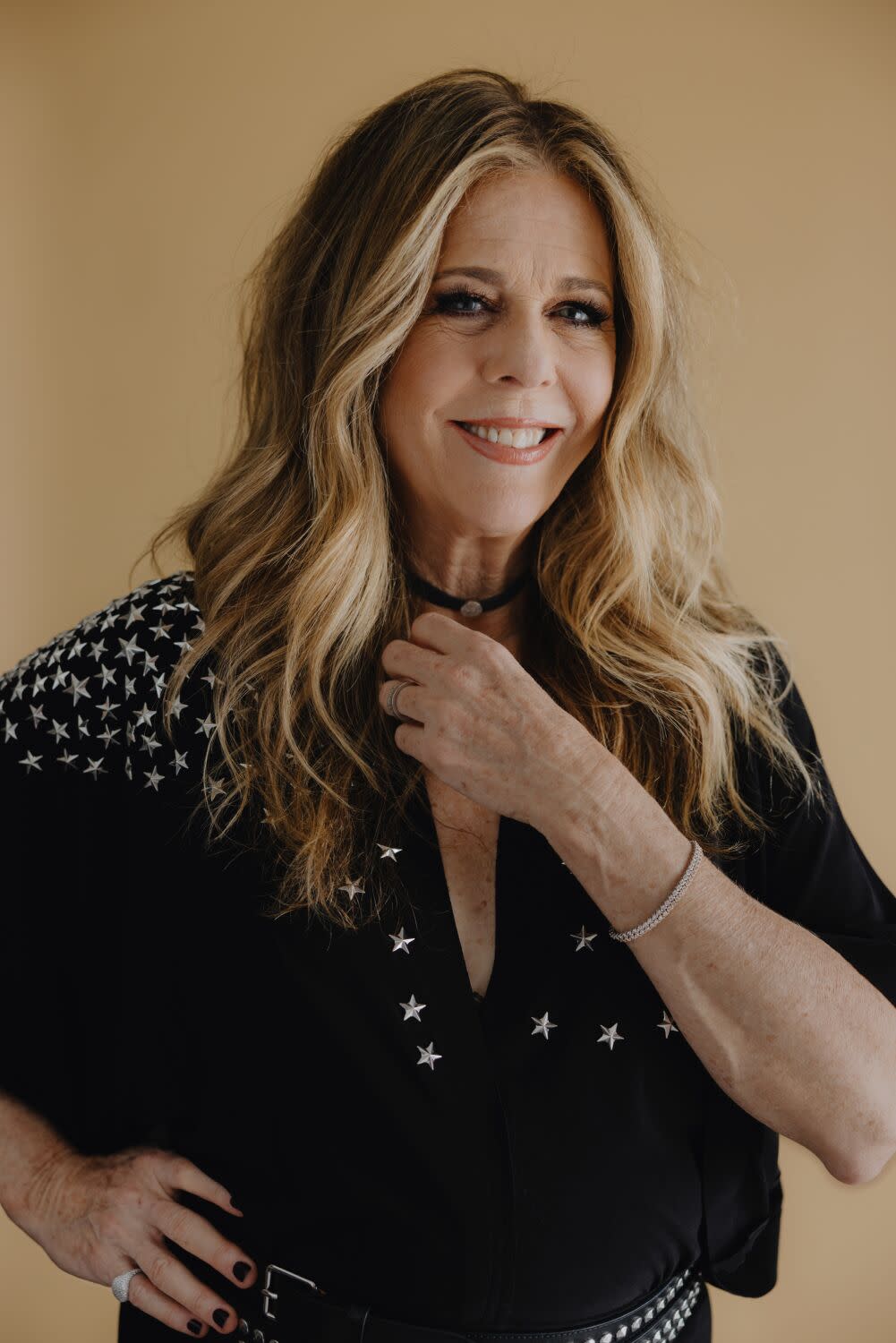 Rita Wilson wears a black top with stars for a portrait.