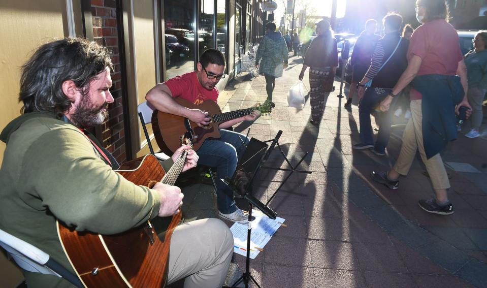 Craig Kauffman and Gabriel Searles of Perfect Strangers perform during the 2021 Music Walk in front of Moorman Clothiers in downtown Ames. Perfect Strangers returns to the Music Walk Thursday evening and will perform at Whiskey River this year. The group plays rock and '90s grunge.