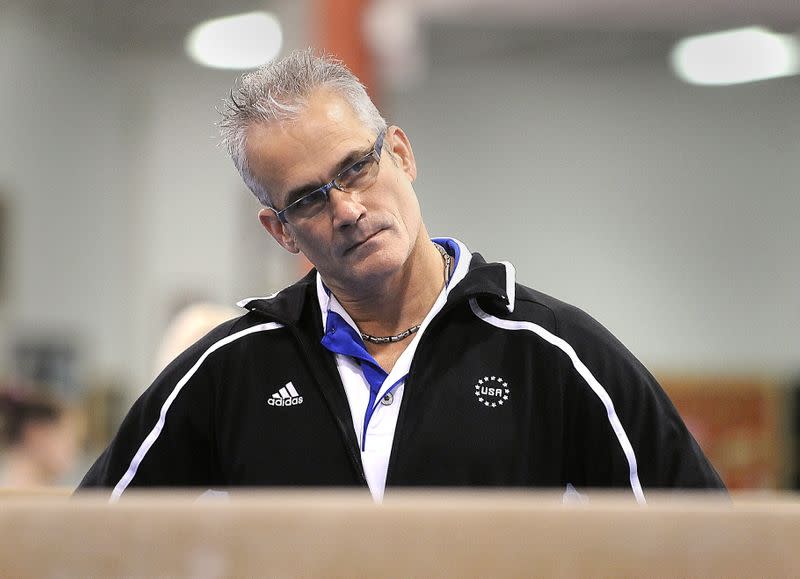 Gymnastics coach John Geddert watches his students during a practice in Lansing