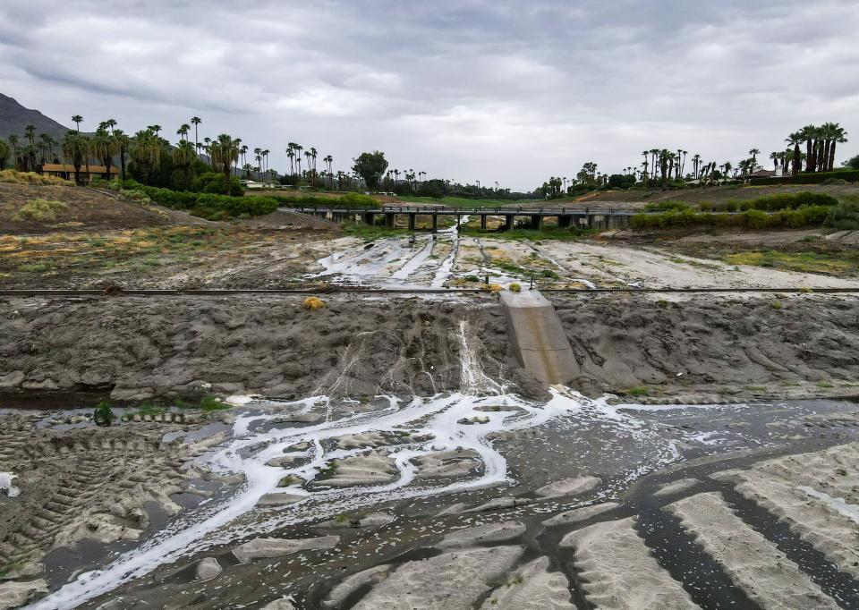 Flood water flows along the storm channel as seen behind the Rancho Mirage Library & Observatory in Rancho Mirage, Calif., Sunday, Aug. 20, 2023.