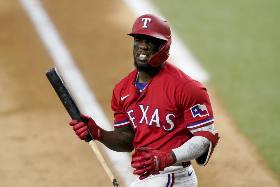 Texas Rangers' Adolis Garcia walks out of the batters box after swinging at a pitch in the seventh inning of a baseball game against the Chicago White Sox in Arlington, Texas, Friday, Sept. 17, 2021. Garcia struck out in the at-bat. (AP Photo/Tony Gutierrez)