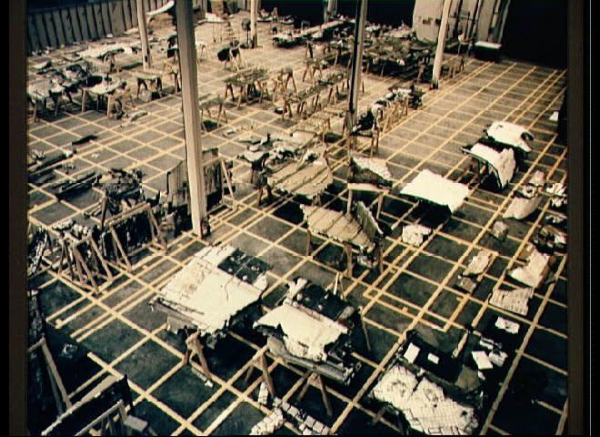 Wide angle view of debris in the Lockheed Log building 113. Debris is on pallets waiting to be identified. The photo was taken from above the floor of the facility. (NASA)