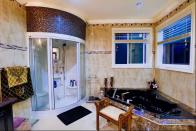 <p>The master bath has a soaking tub with jets as well as a large shower. (Airbnb) </p>