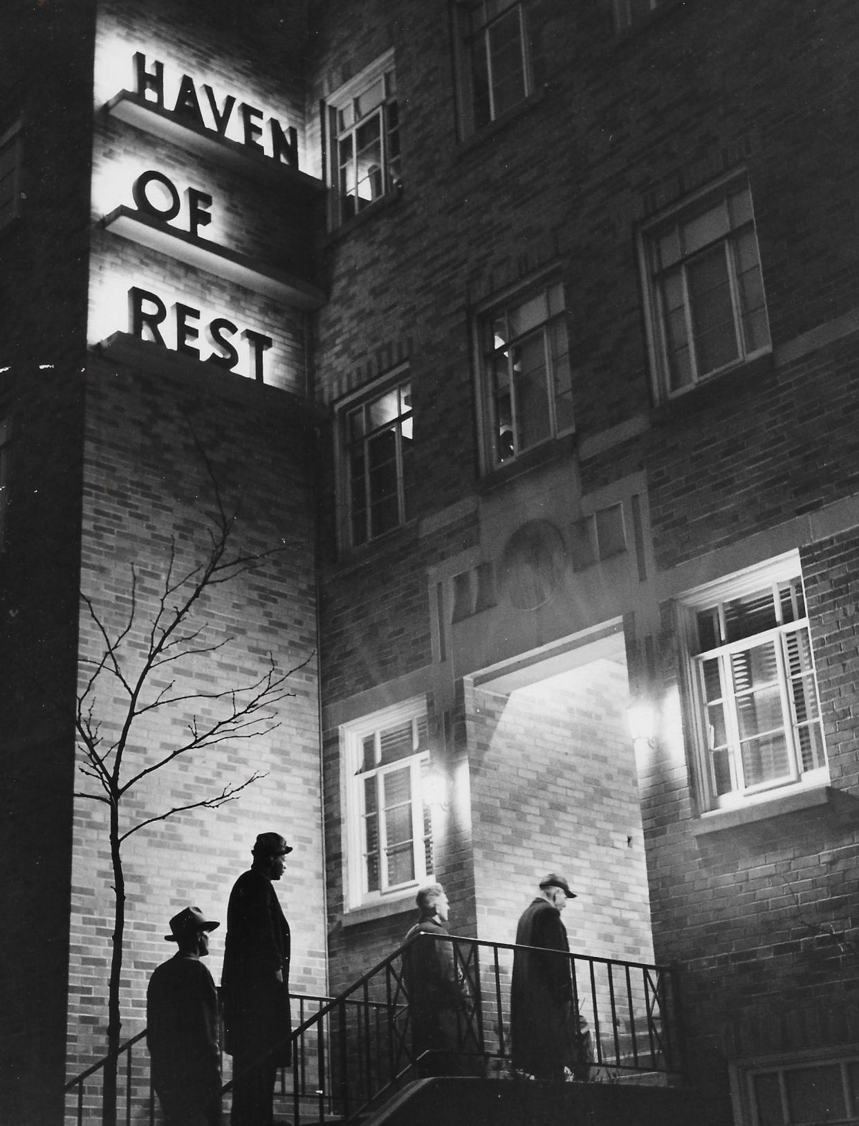 Men enter the Haven of Rest at night in 1958 at 200 E. Buchtel Ave. near the University of Akron.