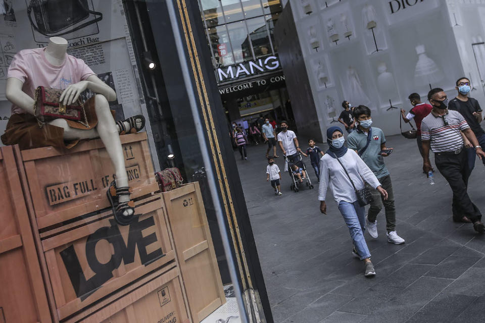 Pedestrians wearing face masks at a public area in Kuala Lumpur August 2, 2020. — Picture by Hari Anggara