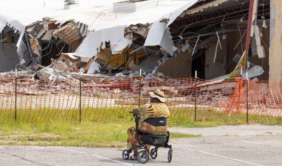 Juliaette Smith watches  from her wheelchair in the parking lot as the Martin Luther King Jr. Recreation Center is torn down on Monday. Smith was a former supervisor at the center working with children.