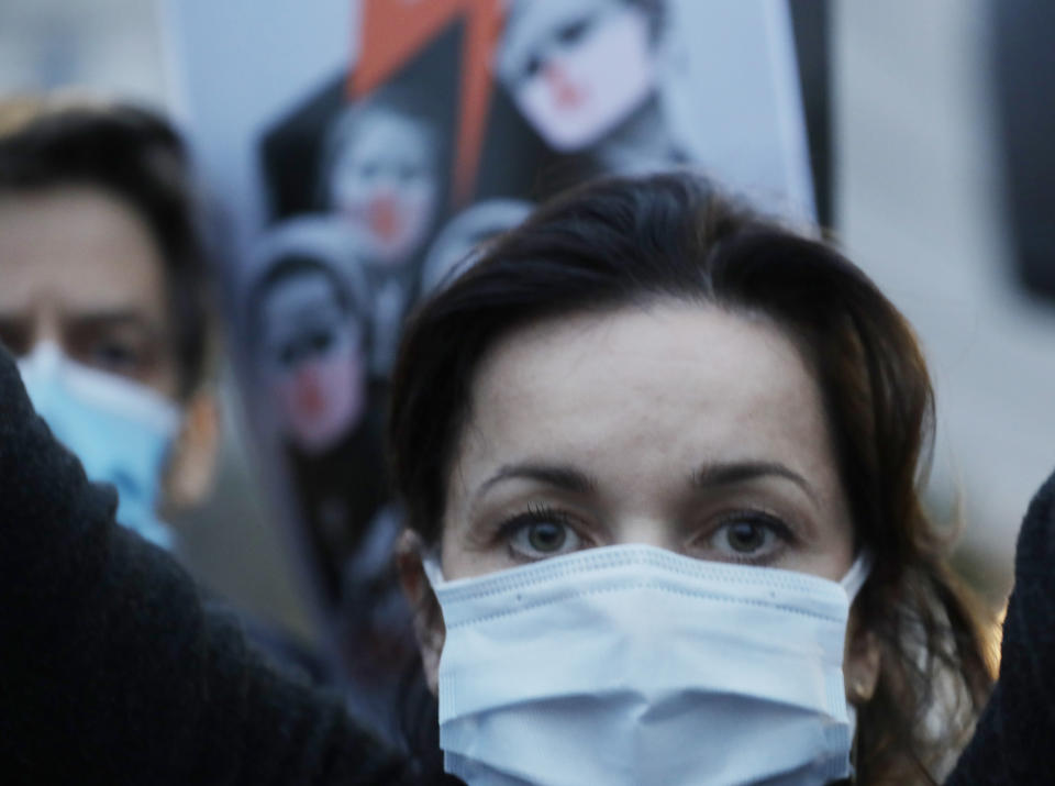 Angered women's rights activists and their supporters block rush-hour traffic at a major roundabout on the fifth day of nationwide protests against recent court ruling that tightened further Poland's restrictive abortion law, in Warsaw, Poland, on Monday, Oct. 26, 2020. The court effectively banned almost all abortions. (AP Photo/Czarek Sokolowski)