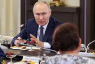 Russian President Vladimir Putin meets with mothers of military personnel serving in the special military operation ahead of Mother's Day at the Novo-Ogaryovo residence outside Moscow, Russia, Friday, Nov. 25, 2022. Mother's Day is celebrated on the last Sunday of November. (Mikhail Metzel, Sputnik, Kremlin Pool Photo via AP)