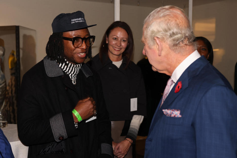 King Charles III (R) speaks with British-Sierra Leonean designer Foday Dumbuya at the Victoria and Albert Museum, while visiting the Africa Fashion exhibition in London.