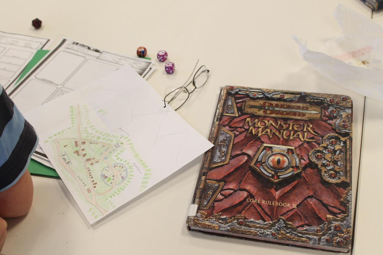 A Dungeons & Dragons map and "Monster Manual" are shown during campaign play at the Herrick District Library in Holland, Michigan. Local kids will have the chance to play a weeklong session of DnD at the Marion Art Center in August.