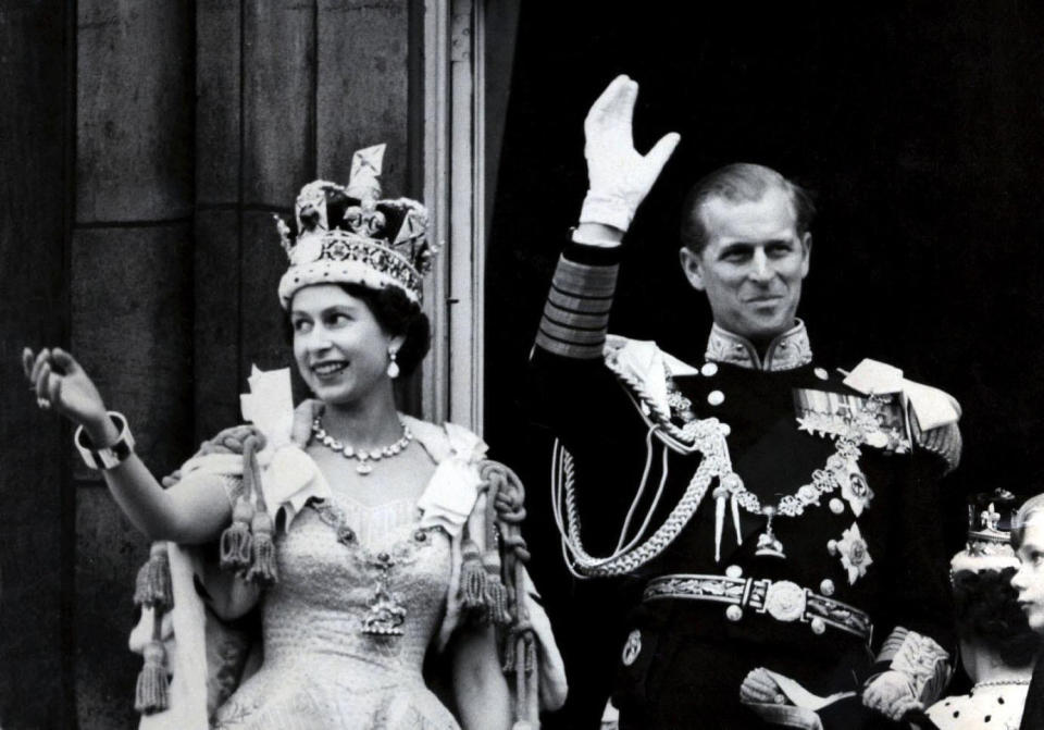 File photo dated 02/06/1953 of Queen Elizabeth II wearing the Imperial State Crown, and the Duke of Edinburgh, in the uniform of Admiral of the Fleet, waving from the balcony of Buckingham Palace after the Queen&#39;s Coronation. The Royal couple will celebrate their platinum wedding anniversary on November 20.