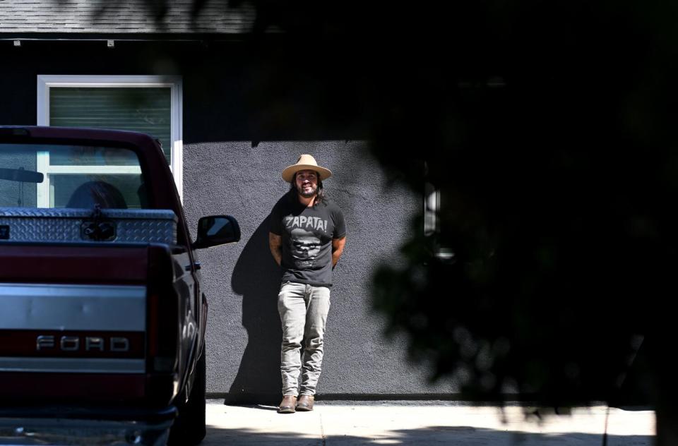 Julio Arana stands outside one of his rental properties in Santa Ana.