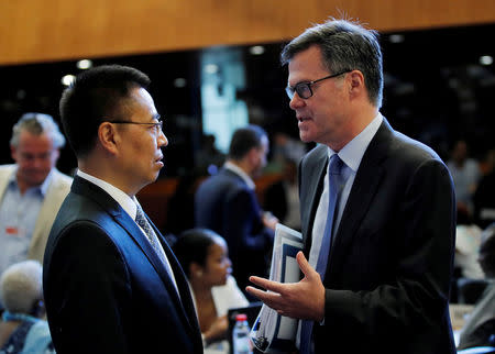 FILE PHOTO: Dennis Shea (R) U.S. Ambassador to the WTO talks with Zhang Xiangchen, Chinese Ambassador to the WTO before the General Council meeting at the World Trade Organization (WTO) in Geneva, Switzerland, July 26, 2018. REUTERS/Denis Balibouse/File Photo