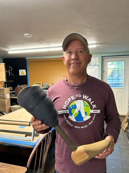 Inventor and founder Phil Johnson holds a Hope to Walk prosthetic leg. Five people from Waynesboro’s Otterbein Church are part of a group delivering 100 legs to amputees in Vietnam.