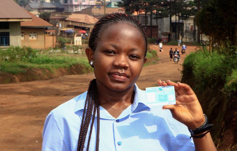 Stephanie Mbafumoja, a Congolese law student holds her voter identity card in L'avenue de L'itav in Butembo