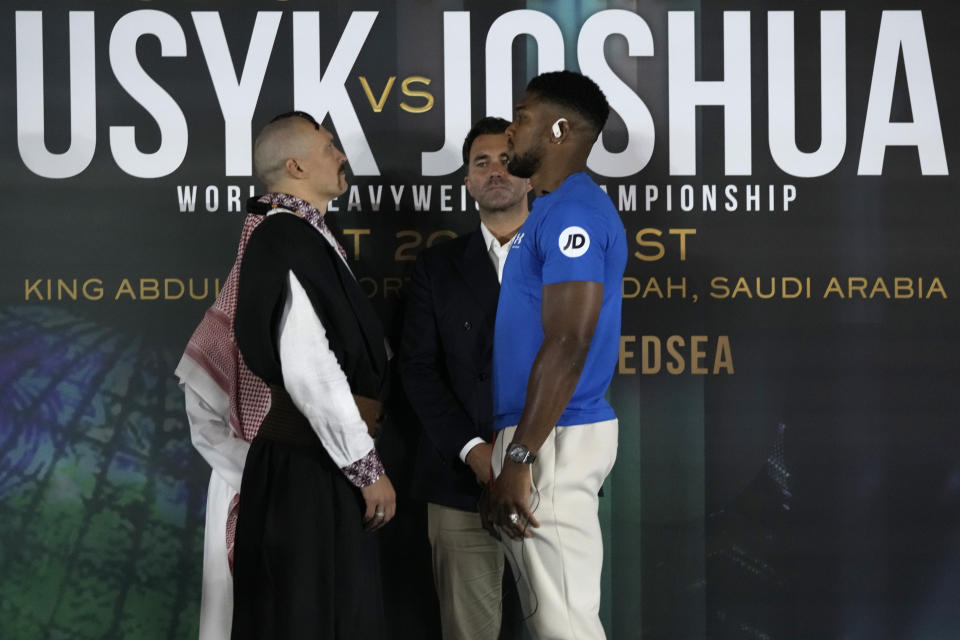 Britain's Anthony Joshua, right, and Ukraine's Oleksandr Usyk face off after their press conference in Jeddah, Saudi Arabia, Wednesday, Aug. 17, 2022. Joshua is due to fight defending champion Usyk in a heavyweight boxing rematch in Jeddah on Aug. 20. (AP Photo/Hassan Ammar)